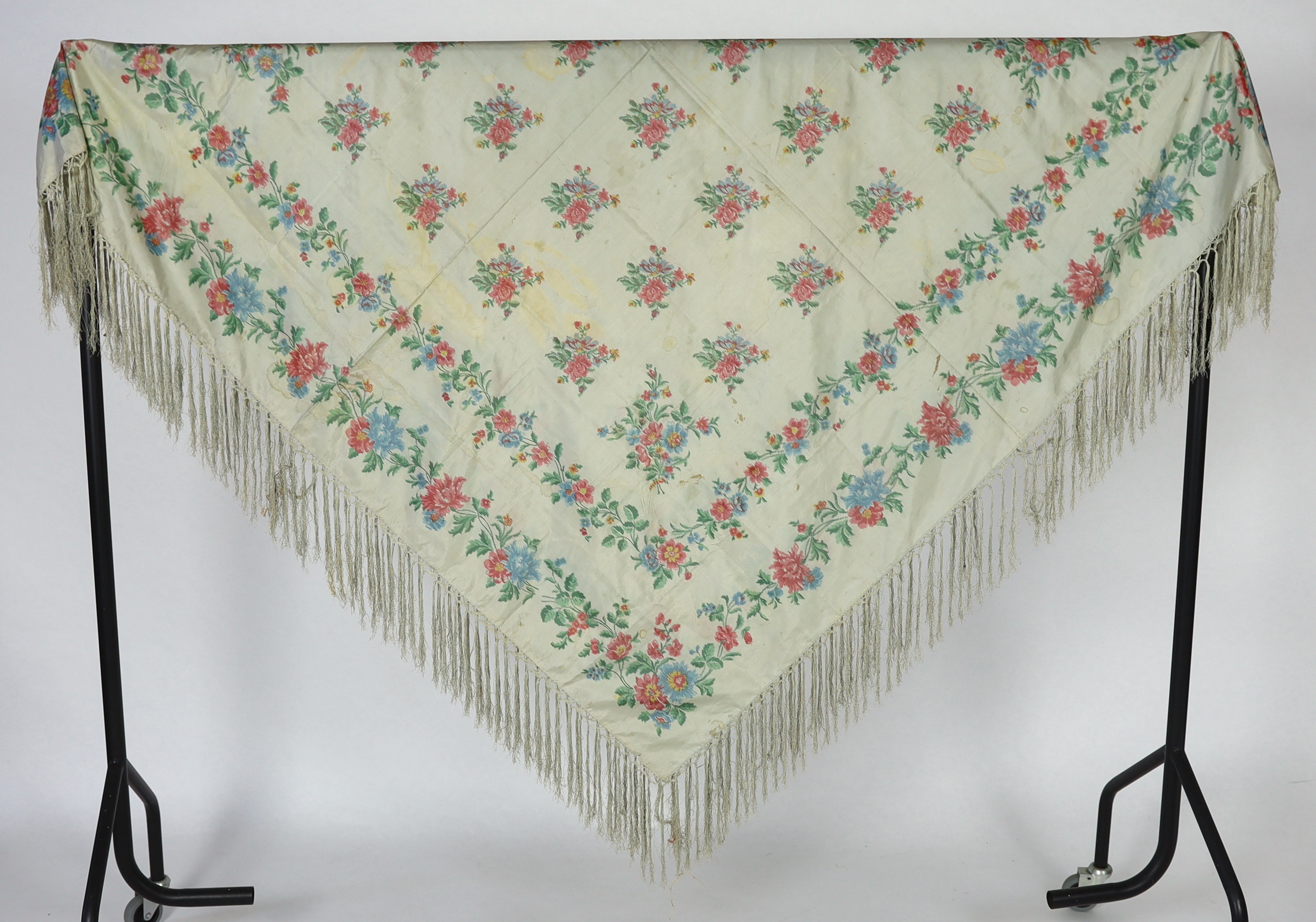 A French silk shawl, c.1800-1840, of a type modelled by Madame Recamier in the painting by François Gerard, printed on the warp thread into a rose pattern, with long fringing, 174 x 170cm
